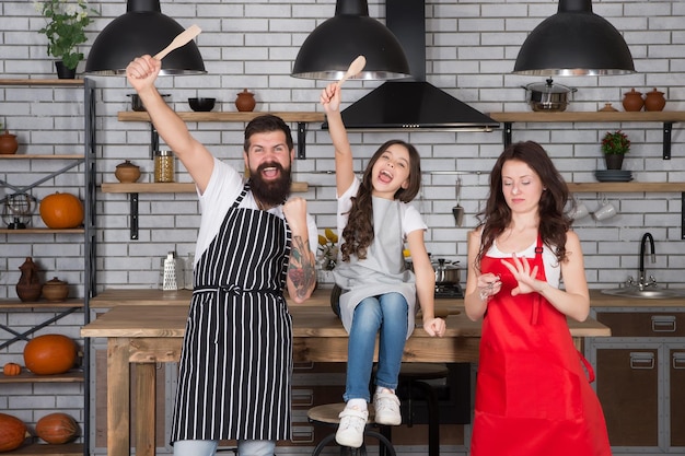 Going crazy together child with parents doing morning breakfast friendly family in kitchen mothers day cooking healthy food at home Family Preparing Meal In Kitchen happy family in the kitchen