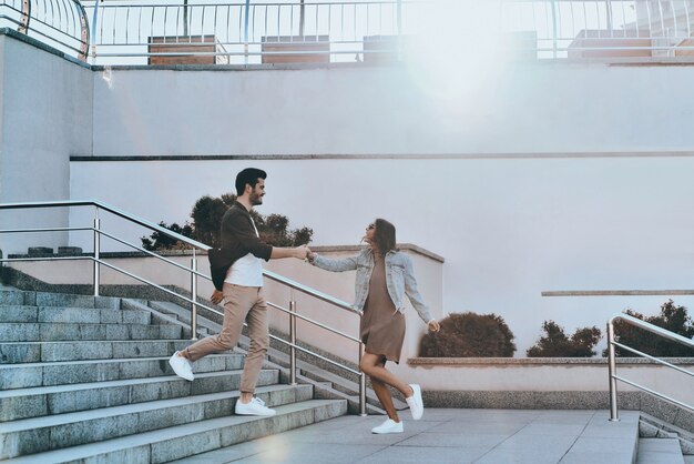 Going crazy together. Full length of handsome man and young attractive woman holding hands 