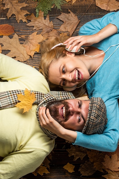 Going crazy together. happy couple in love lying on fall background. Excited fall couple on romantic date. enjoying life and freedom. love. happy thanksgiving day. family play in autumn leaves.