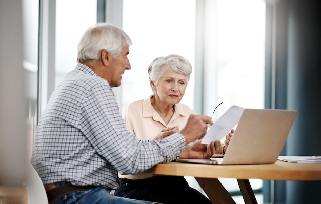 Going over their finances Cropped shot of a senior couple working on their finances at home