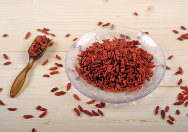 Goji berries in transparent glass bowl with goji berries on the table