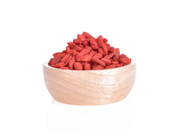 Goji berries in wooden bowl isolated.