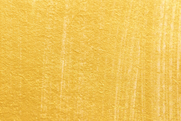 Gold acrylic paint texture on white paper