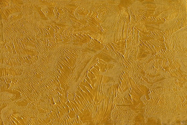 段ボール紙の背景に描かれたゴールドのアクリル テクスチャ