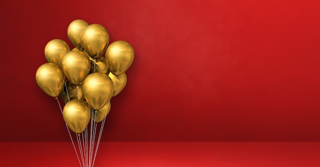 Gold balloons bunch on a red wall