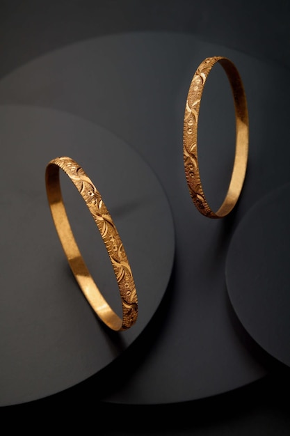 Gold bangle on black round shape background