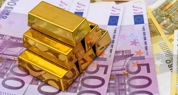 Gold bars on euro bills investment saving concept 100 200 500 Eu money