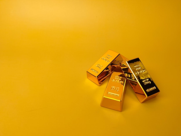 Gold bars and Financial concept and conceptual image on a yellow background with copy and text space