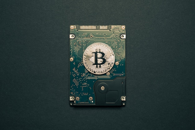 Gold bitcoin on a dard disk drive.