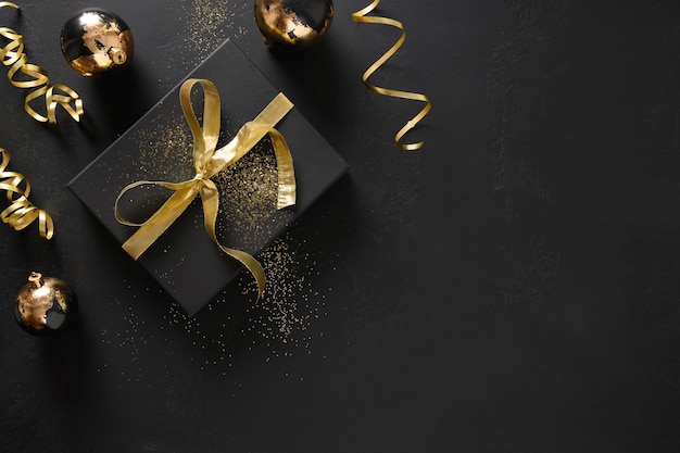 Gold and black gift and baubles with christmas decorations