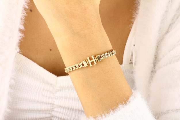 A gold bracelet with the letter h on it.