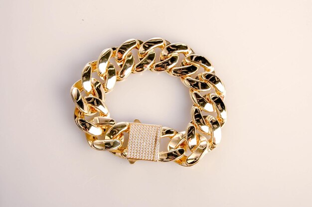 a gold bracelet with a white band that says  gold