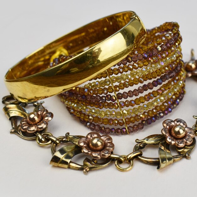 Gold bracelets and earrings on a white background closeup