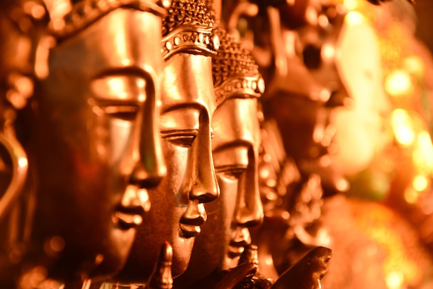 Gold Buddha head arranged with selective focus.