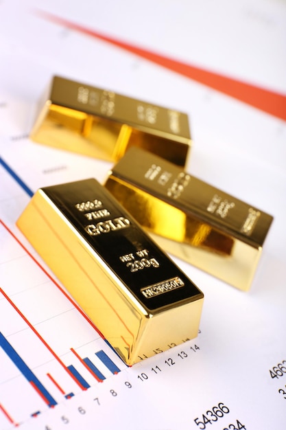 Gold bullion on documents background