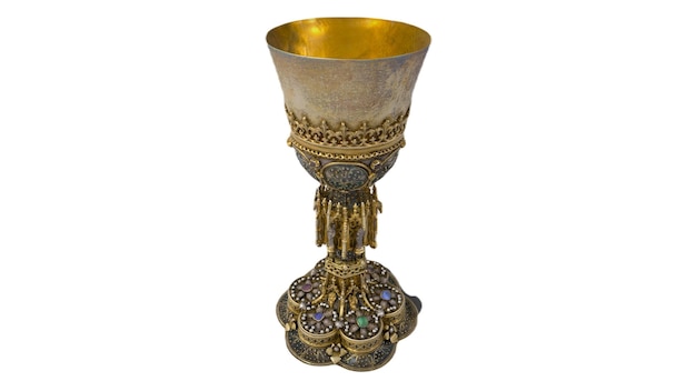 A gold chalice with a green stone on the top.