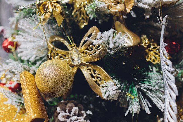 Gold Christmas background of de-focused lights with decorated tree.