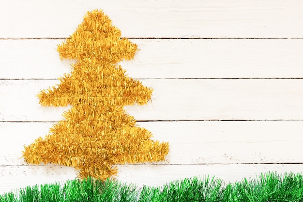 gold Christmas tree on white wall