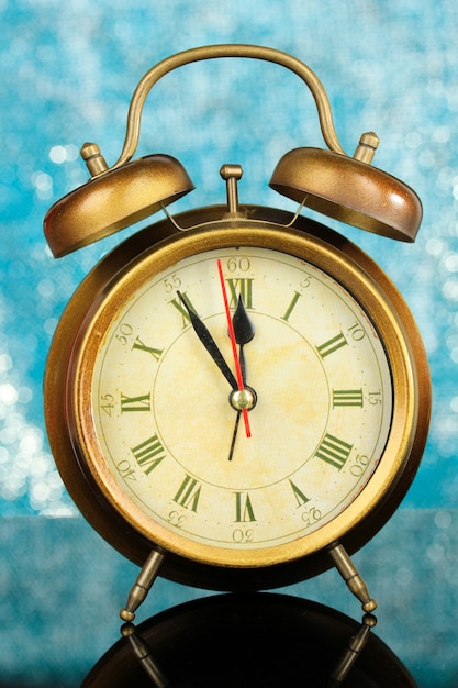 Gold clock on bright background