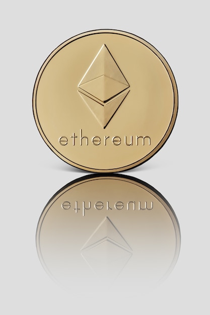 Photo gold coin ethereum. the front side of the coin is reflected on a white glossy surface. ãâ¡ryptocurrency and blockchain concept.