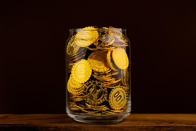 Gold coin in glass bottle on black scene money and gold saving concept