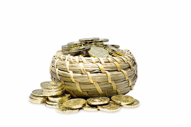 Gold coins in a wicker basket isolated on a white background