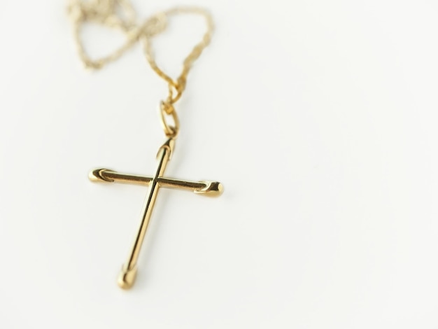 A gold cross on a white background