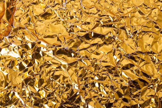 Gold crumpled foil paper texture background