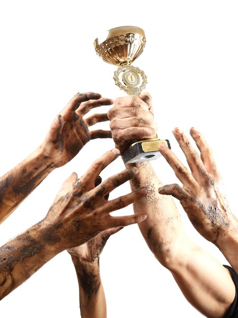 Photo gold cup in hands isolated on white