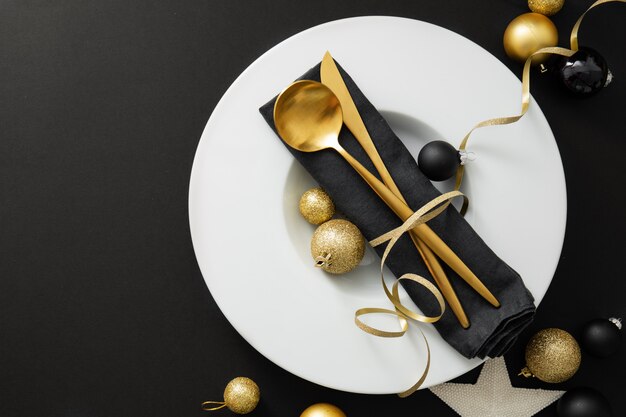 Gold cutlery served on plate for Christmas Dinner