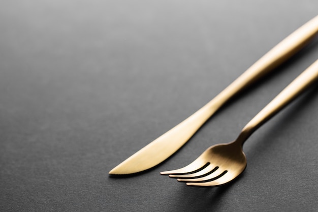 Gold cutlery set on black 