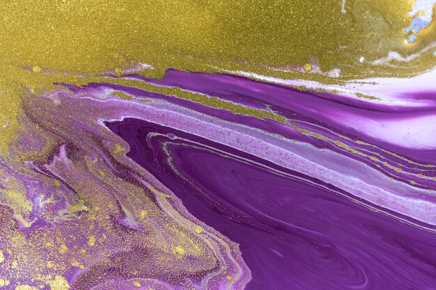 Gold dust on violet liquid acrylic artwork background