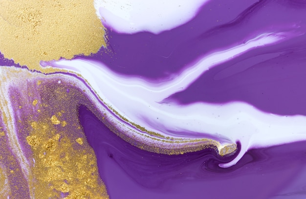 Gold dust on violet liquid acrylic artwork background