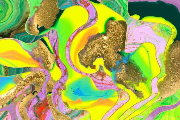 Gold dust and waves on fluorescent inks background