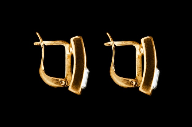 Gold earrings on black