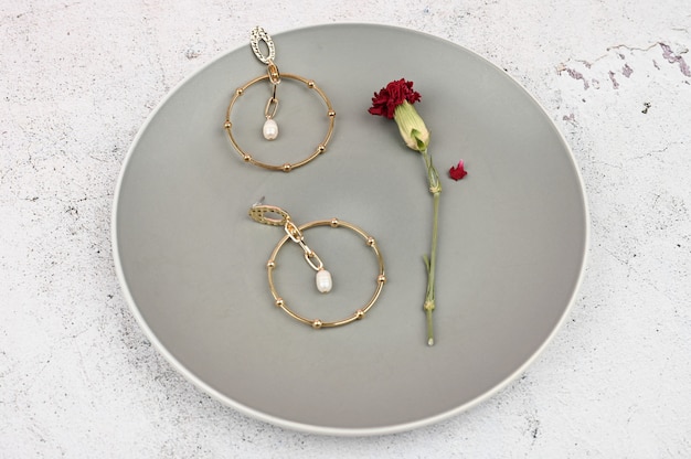 Gold earrings in a plate