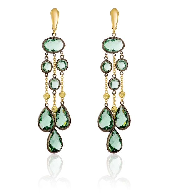 Gold earrings with green stones on a white background with reflection