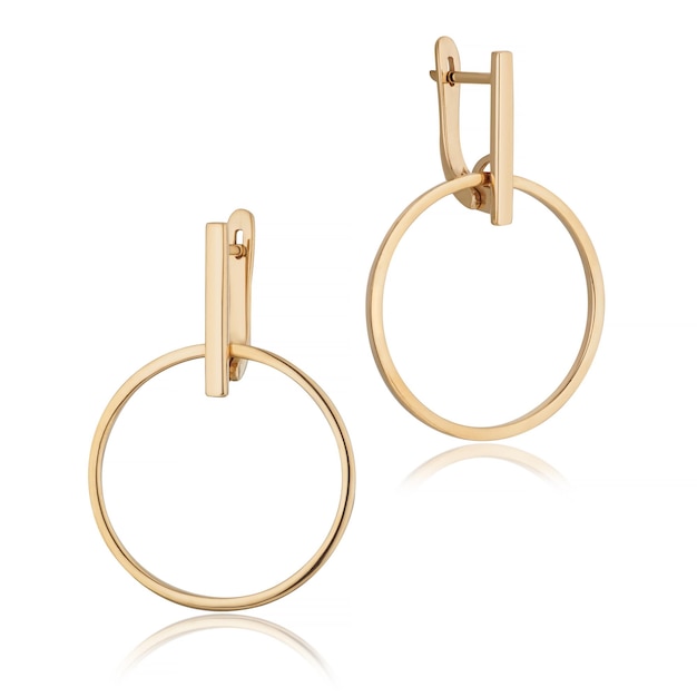 Gold earrings with reflection on white background