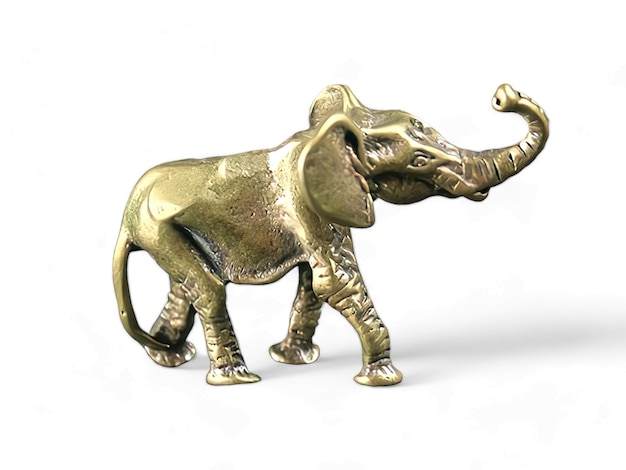 Gold elephant statue with a trunk on its head isolated on white