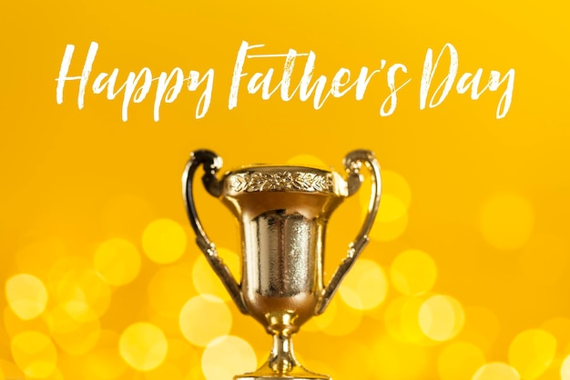 Gold father's day award trophy against bright yellow background