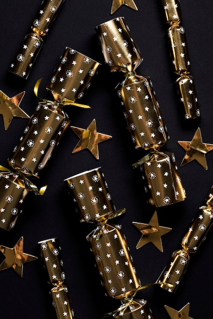 Gold festive christmas crackers on a dark background