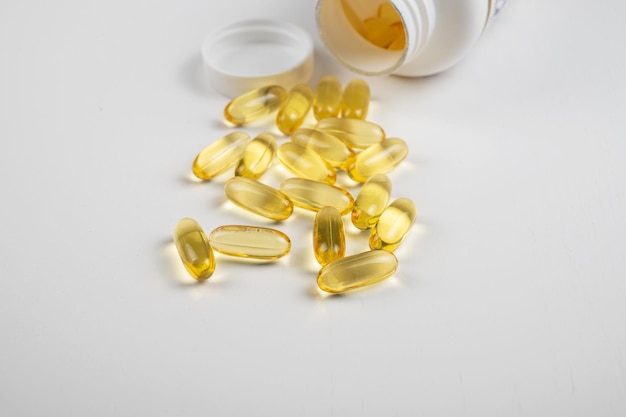 Gold fish oil isolated on white background pile of fish oil with omega  acid vitamin d or vitamin e