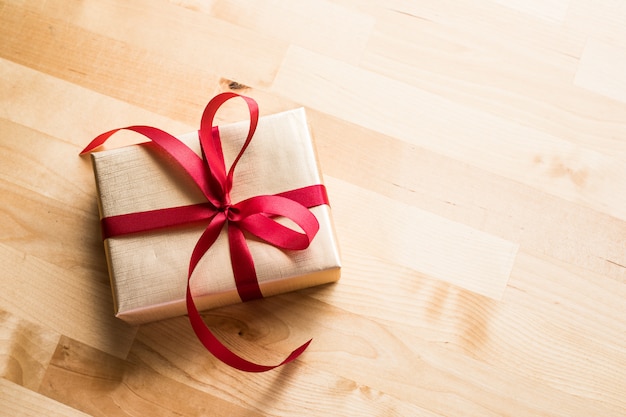 Gold gift box on wooden table