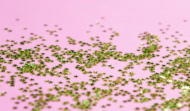 Gold glitter on a pink surface