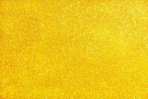 ゴールドのキラキラテクスチャ輝く光沢のある包装紙の背景