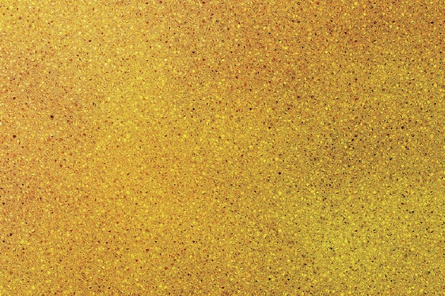 Foto consistenza luccicante dorata che è dorata con uno sfondo dorato
