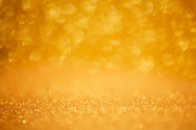 Gold glittering christmas lights. Blurred abstract background.