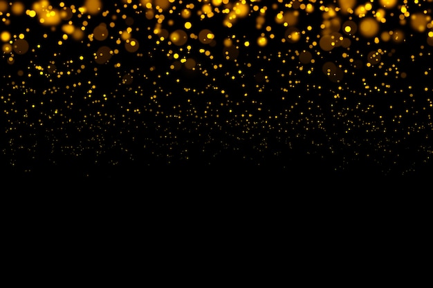 ゴールドのきらびやかな光ボケ抽象的な粒子が暗い背景に。