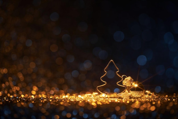 금색 반짝이는 크리스마스 트리는 검정색 배경에 검정색 배경에 있습니다.
