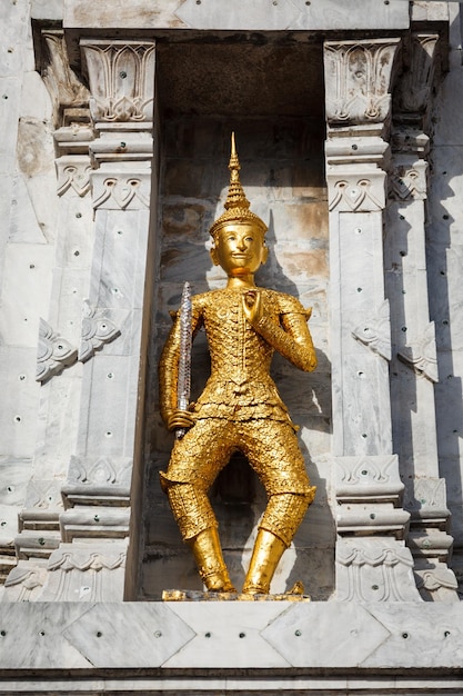 Gold guard on tower Wat Phi Thailand